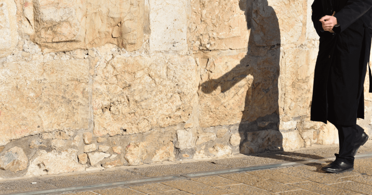 picture of Jewish man with shadow walking by the Western Wall for the No Jew Left Behind blog